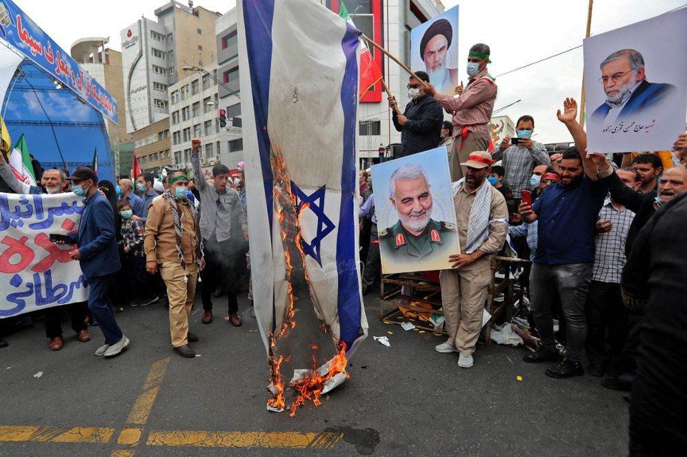 Iranians set an Israeli flag on fire as they march during a rally marking Al-Quds Day, in Tehran, Iran.