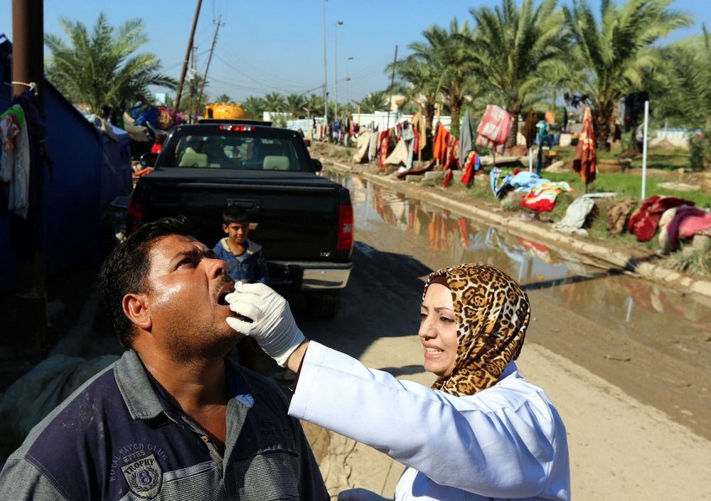 An Iraqi man receives a dose of cholera vaccine at the Jamiyah district in Baghdad, Iraq on November 1, 2015.