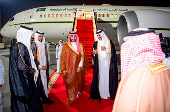 Saudi Crown Prince Mohammed bin Salman, center left, is greeted by Qatar's Emir Sheikh Tamim bin Hamad Al Thani upon his arrival at Doha airport in Qatar