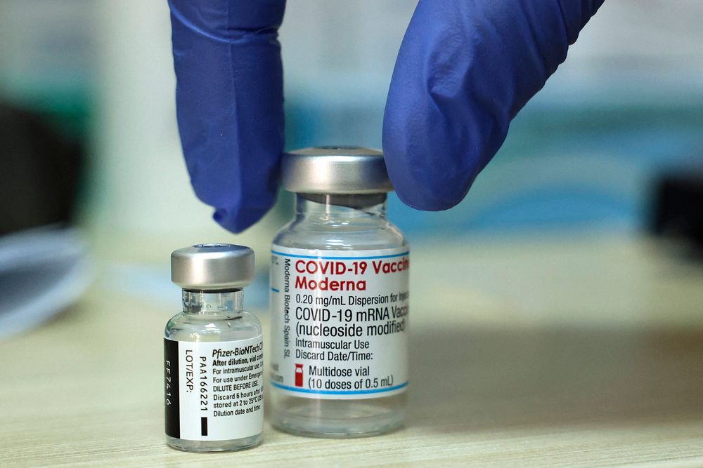 Two vials of the coronavirus vaccine, Pfizer-BioNTech and Moderna, at a Clalit Health Services medical center in Jerusalem on August 10, 2021.