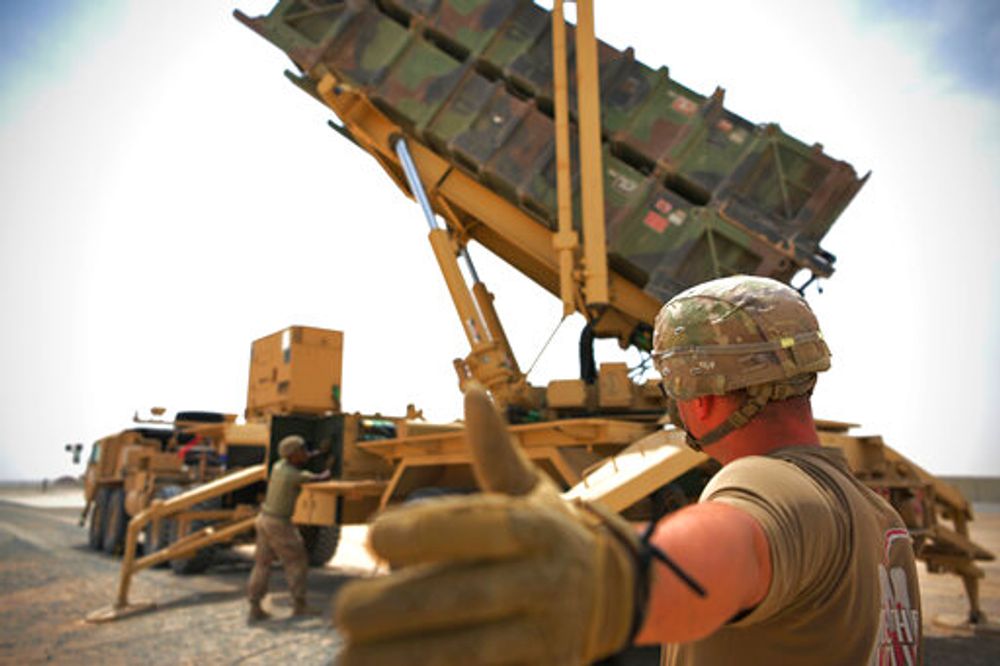 US Army Specialist Scottlin Bartlett signals to a colleague while working near a Patriot missile battery at Al-Dhafra Air Base in Abu Dhabi, the United Arab Emirates, on May 5, 2021.