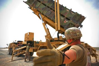 Staff Sgt. Jao'Torey Johnson/U.S. Air Force via AP US Army Spc. Scottlin Bartlett signals to a colleague while working near a Patriot missile battery at Al-Dhafra Air Base in Abu Dhabi, United Arab Emirates, May 5, 2021.