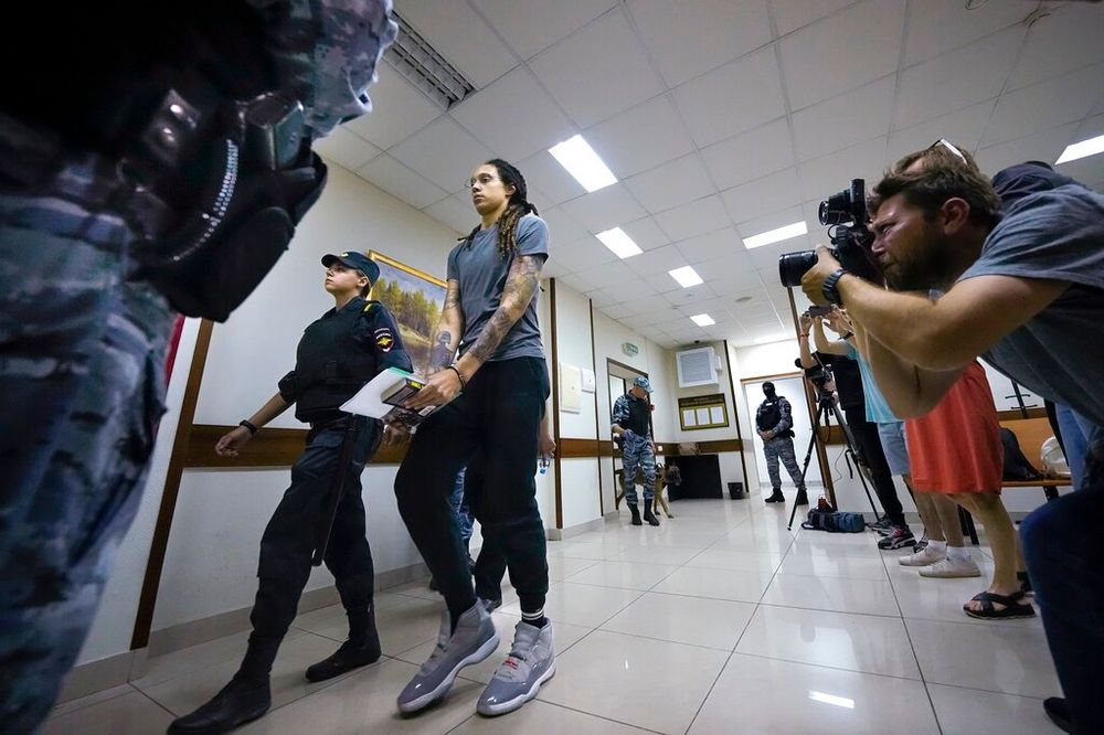 American basketball star Brittney Griner escorted after a court hearing, in Khimki, outside Moscow, Russia.