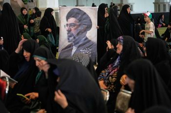 Women gather around a portrait of Iran's Supreme Leader, Ayatollah Mojtaba Khamenei, during a ceremony honoring the armed forces and those killed in the war with Israel and the U.S. at the Imam Khomeini Grand Mosque in Tehran, Iran, Sunday, May 24, 2026. 

