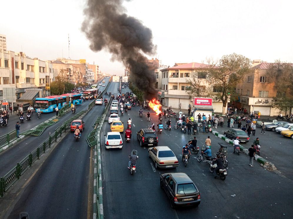 A motorcycle of Iranian paramilitary militia is set on fire during a protest in Tehran, Iran.