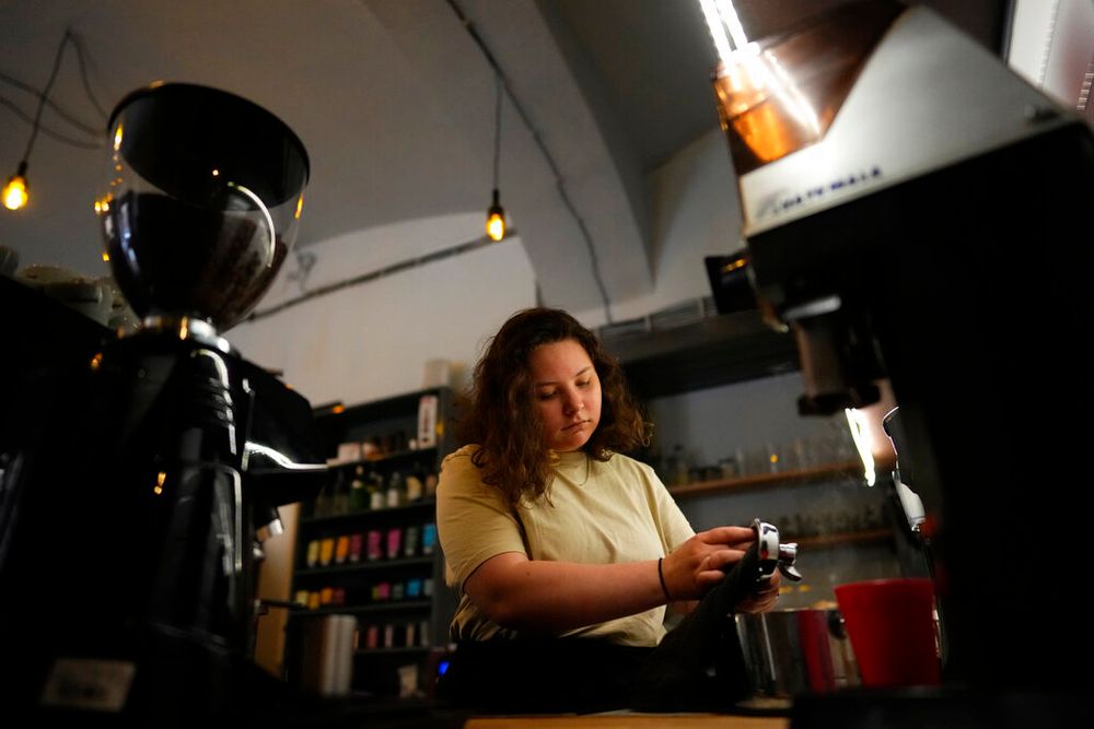 Ukrainian refugee Lisa Himich prepares coffee at a shop where she works, on July 15, 2022, in Prague, Czech Republic.