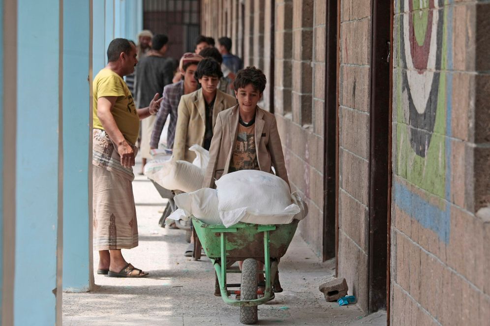 Displaced Yemenis receive food supplies provided by the World Food Programme, at a school in Sanaa, Yemen, on August 25, 2019.