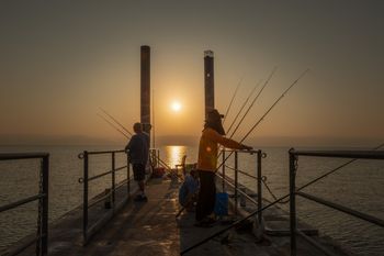 The sun sets at the Ginosar beach at the Kinneret, the Sea of Galilee, in northern Israel, on October 19, 2019