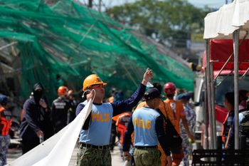 Rescuers work on a collapsed building where dozens are believed to be trapped in Angeles city in Pampanga province, north of Manila, Philippines Sunday, May 24, 2026. 
