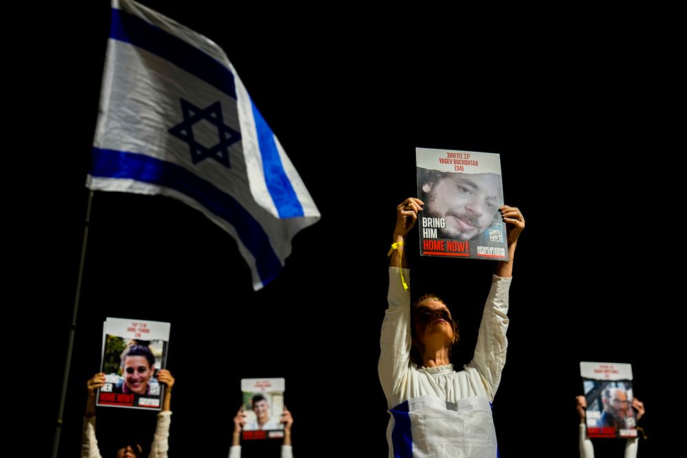 Families and supporters of Israeli hostages held by Hamas in Gaza hold their photos and shout slogans during a rally calling for their release, in Tel Aviv, Israel.