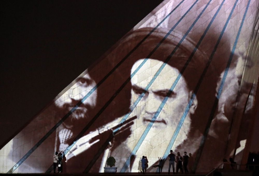Iran's Azadi tower is illuminated with pictures of the late supreme leader Ayatollah Ruhollah Khomeini in the capital Tehran, on June 3, 2022.