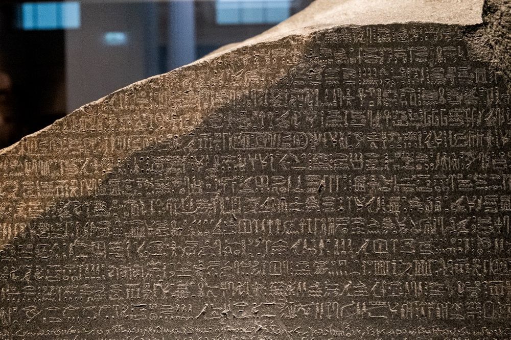 The top portion of the Rosetta Stone showing the ancient Egyptian hieroglyphic text, at the British Museum in London, England.