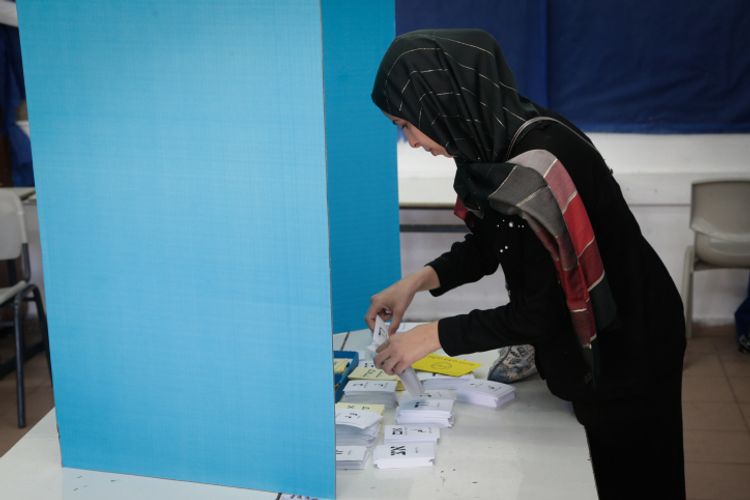 An Arab Israeli woman casts her ballot at a voting station during the Municipal Elections, on October 30, 2018, in Kafr Qasim, Israel.