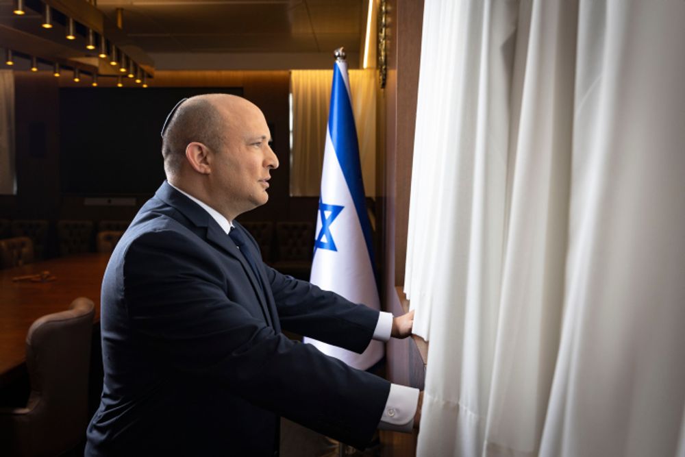 Israel's Prime Minister Naftali Bennett poses for a picture at the Prime Minister's office in Jerusalem, January 26, 2022.