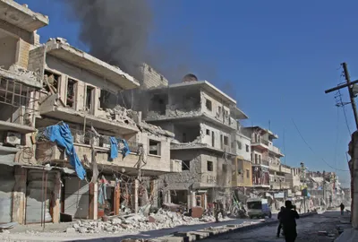 2019年12月20日に国の最後の主要な野党の砦であるシリアのイドリブ州のマーレアルヌマンの町で、親シリア政府軍による報告された砲撃の後、建物から大波を吹きます。