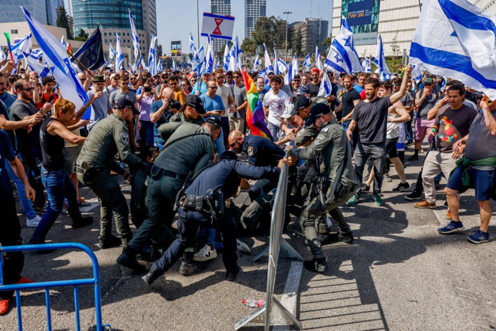 Israelis clash with police during a protest against the Israeli government's planned judicial overhaul, in Tel Aviv.
