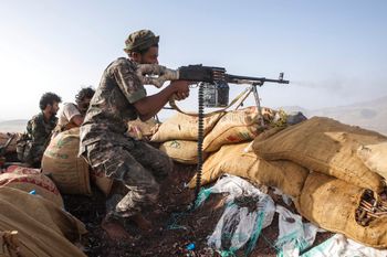 A Yemeni fighter backed by the Saudi-led coalition fires his weapon during clashes with Houthi rebels on the Kassara frontline near Marib, Yemen, June 20, 2021.