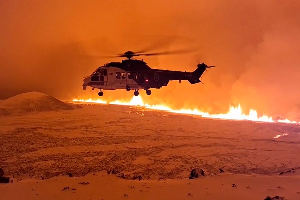 This image made from video provided by the Icelandic Coast Guard shows its helicopter flying near magma running on a hill near Grindavik on Iceland's Reykjanes Peninsula sometime around late Monday, Dec. 18, or early Tuesday, Dec. 19, 2023.