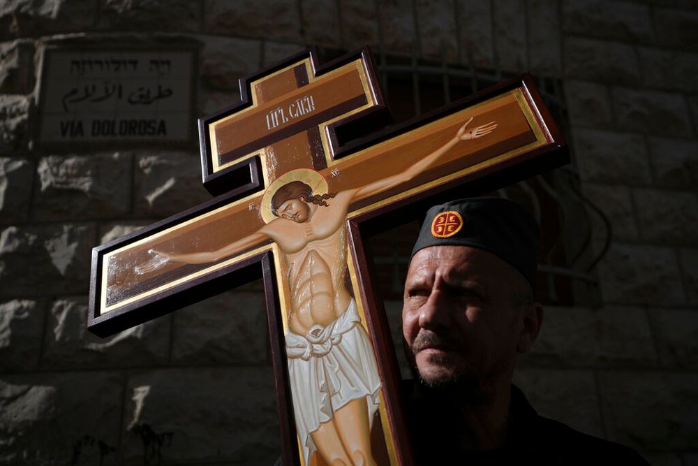 An Orthodox worshipper holds a cross in Jerusalem.