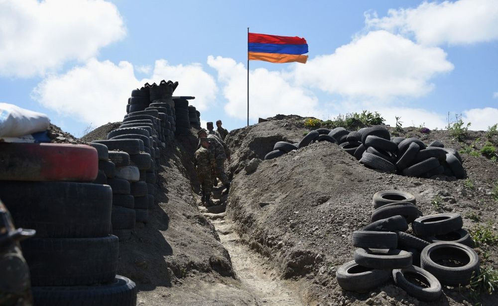 Soldiers walk in a trench at a border check point between Armenia and Azerbaijan near the village of Sotk, Armenia, on June 18, 2021.