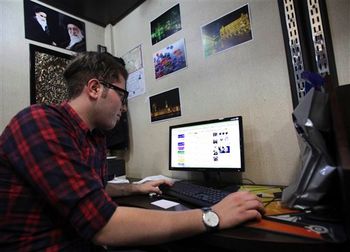 An Iranian man uses a computer in an internet cafe at a shopping center, in central Tehran, Iran, January 6, 2013.