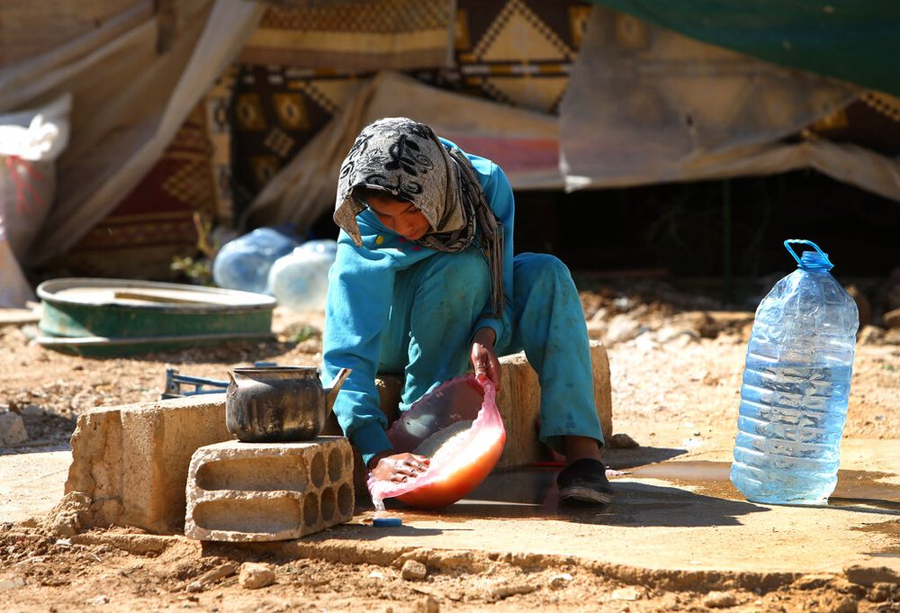 A Syrian refugee girl outside her tent at a temporary refugee camp in the eastern Lebanese town of al-Faour.
