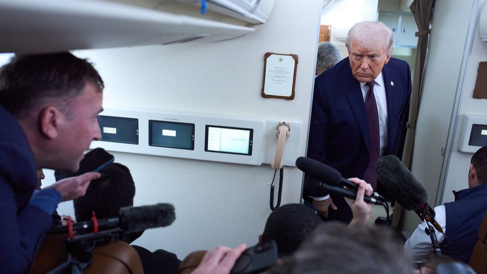 Donald Trump speaks to reporters aboard Air Force One after leaving the World Economic Forum in Davos for Washington, January 22, 2026