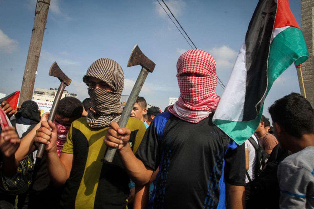 Palestinians take part in an anti-Israel protest in the southern Gaza Strip town of Rafah on October 13, 2015.