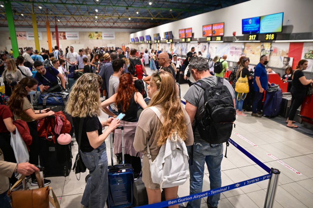Travelers stand in line in Terminal 1 to check in, at Ben Gurion International Airport, central Israel, on July 7, 2022.