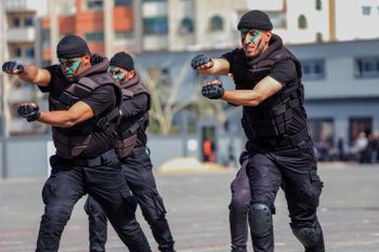 Palestinian Hamas security forces display their military skills during a police academy graduation ceremony in Gaza City, Gaza, on February 21, 2022.