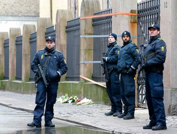 A Danish police officers secure the area outside of a synagogue, Sunday, Feb. 15, 2015, where a gunman opened fire in Copenhagen, Denmark.