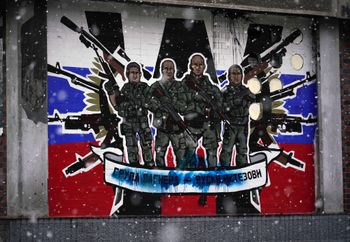 This picture shows a defaced mural to the glory of Russia's mercenary group Wagner reading 