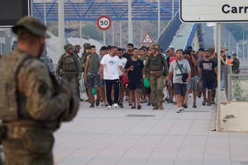 Escorted by the Spanish army, migrants who crossed into Spain return to Morocco from the Spanish enclave of Ceuta on Saturday, Aug. 1, 2026
