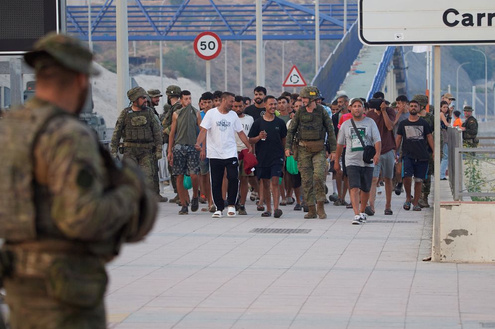 (AP Photo/Antonio Sempere) Escorted by the Spanish army, migrants who crossed into Spain return to Morocco from the Spanish enclave of Ceuta on Saturday, Aug. 1, 2026