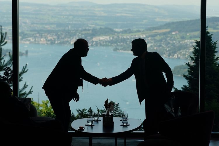 Delegation staff members meet in the lobby on the first day of a quadrilateral meeting between the U.S., Iran, Pakistan, and Qatar at the Buergenstock Resort Lake Lucerne, near Stansstad, Switzerland, Sunday, June 21, 2026