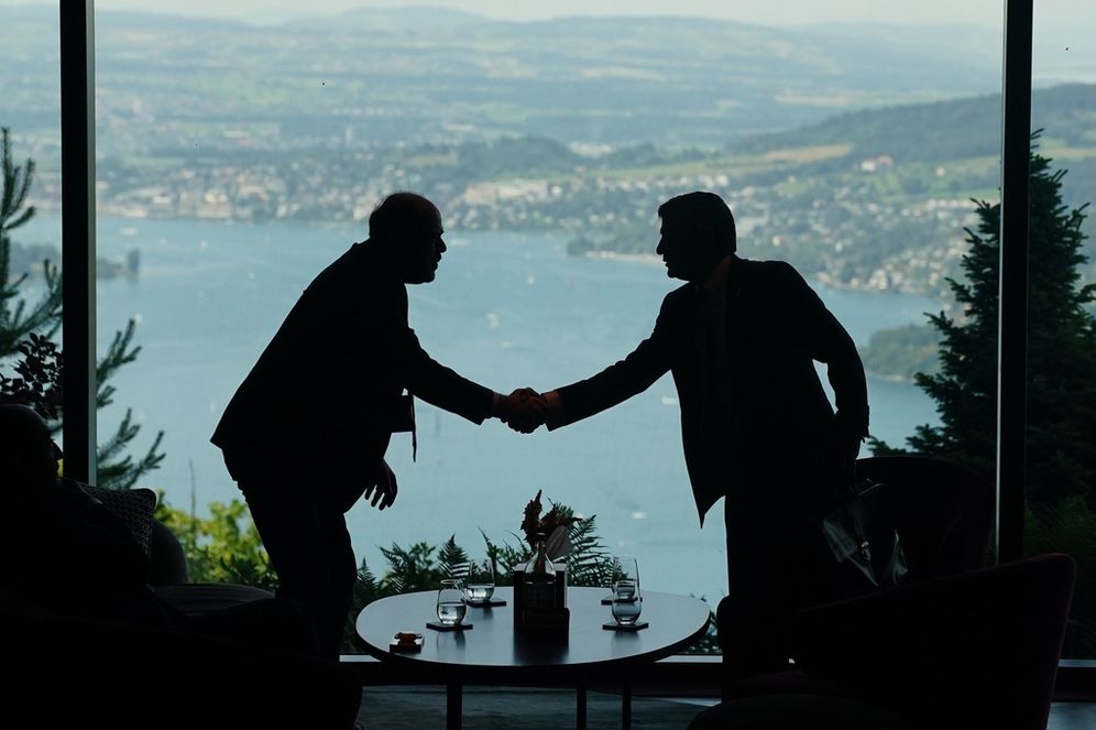 Nathan Howard/Pool Photo via AP Delegation staff members meet in the lobby on the first day of a quadrilateral meeting between the U.S., Iran, Pakistan, and Qatar at the Buergenstock Resort Lake Lucerne, near Stansstad, Switzerland, Sunday, June 21, 2026