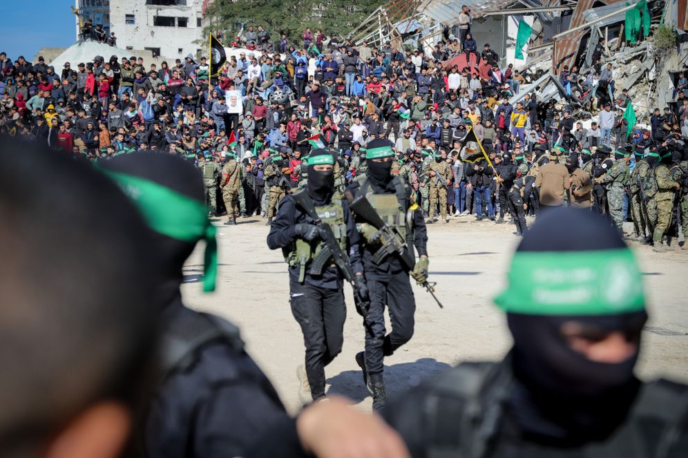 Al-Qassam Brigades, the military wing of Hamas, hand over four Israeli hostages to the Red Cross in Palestine Square, in Gaza City
