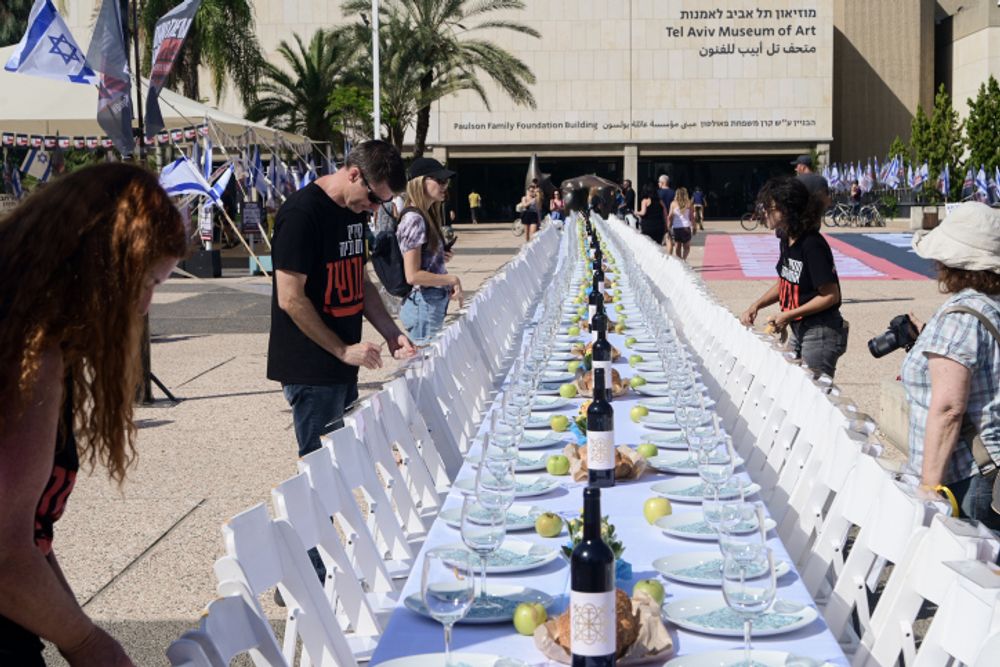 Familiies of Israelis held hostage by Hamas militants in Gaza set a symbolic shabbat table with more than 200 empty seats for the histages, at  "Hostage Square", outside the Art Museum of Tel Aviv, October 20, 2023.