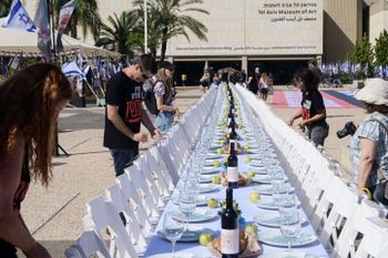 Familiies of Israelis held hostage by Hamas militants in Gaza set a symbolic shabbat table with more than 200 empty seats for the histages, at  "Hostage Square", outside the Art Museum of Tel Aviv, October 20, 2023.
