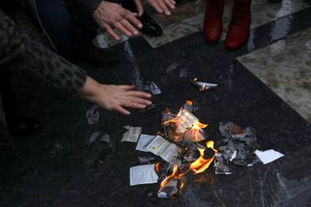 People set fire to their electricity bills during a protest in Ankara, Turkey, on February 9, 2022.