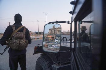 Soldiers formerly with the Kurdish-led Syrian Democratic Forces stand guard in Hasakah, northeastern Syria, Wednesday, Aug. 26, 2026. The force announced its dissolution Tuesday after completing its merger with the Syrian army. 