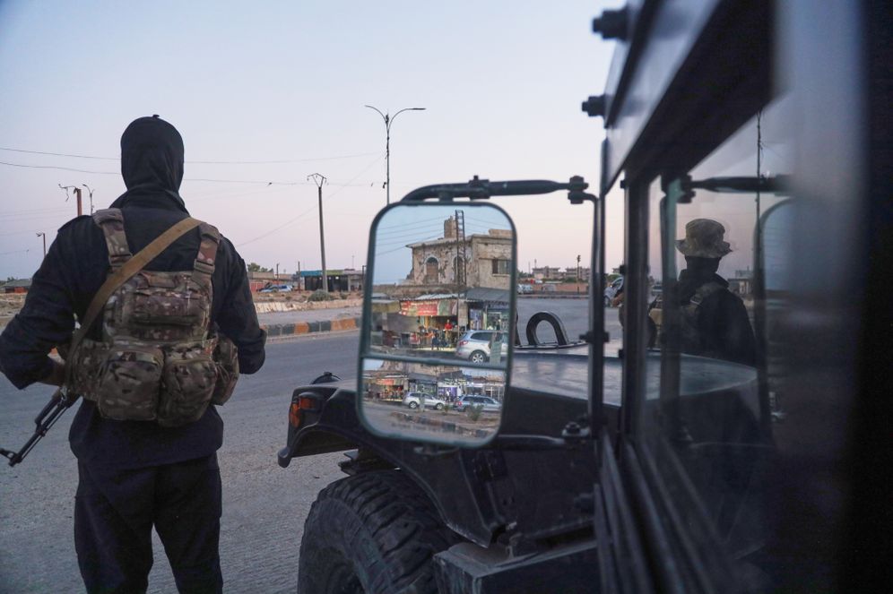(AP Photo/Baderkhan Ahmad) Soldiers formerly with the Kurdish-led Syrian Democratic Forces stand guard in Hasakah, northeastern Syria, Wednesday, Aug. 26, 2026. The force announced its dissolution Tuesday after completing its merger with the Syrian army.