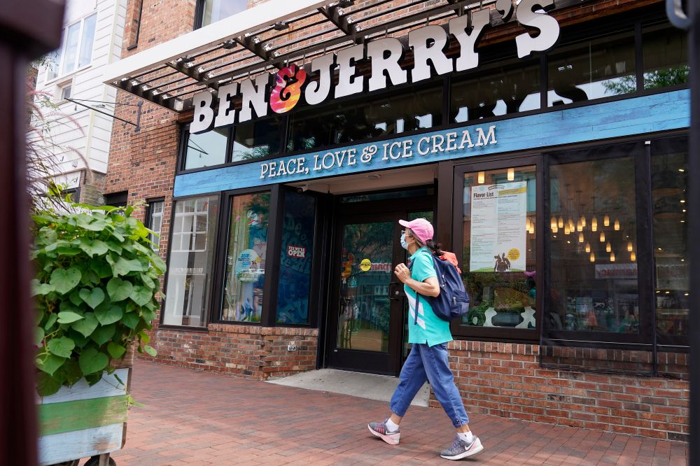 A woman walks past the Ben & Jerry's Ice Cream shop, in Burlington, Vermont, on July 20, 2021.
