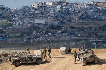 Israeli soldiers take up positions near the Gaza Strip border, in southern Israel, Friday, Dec. 29, 2023.