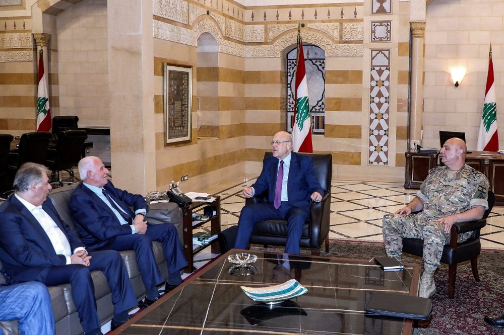 Handout picture provided by the Lebanese photo agency Dalati and Nohra shows Lebanon's caretaker prime minister Najib Mikati (C) meeting with a delegation headed by Azzam al-Ahmad from the Palestinian Fatah movement, at the government palace in Beirut.