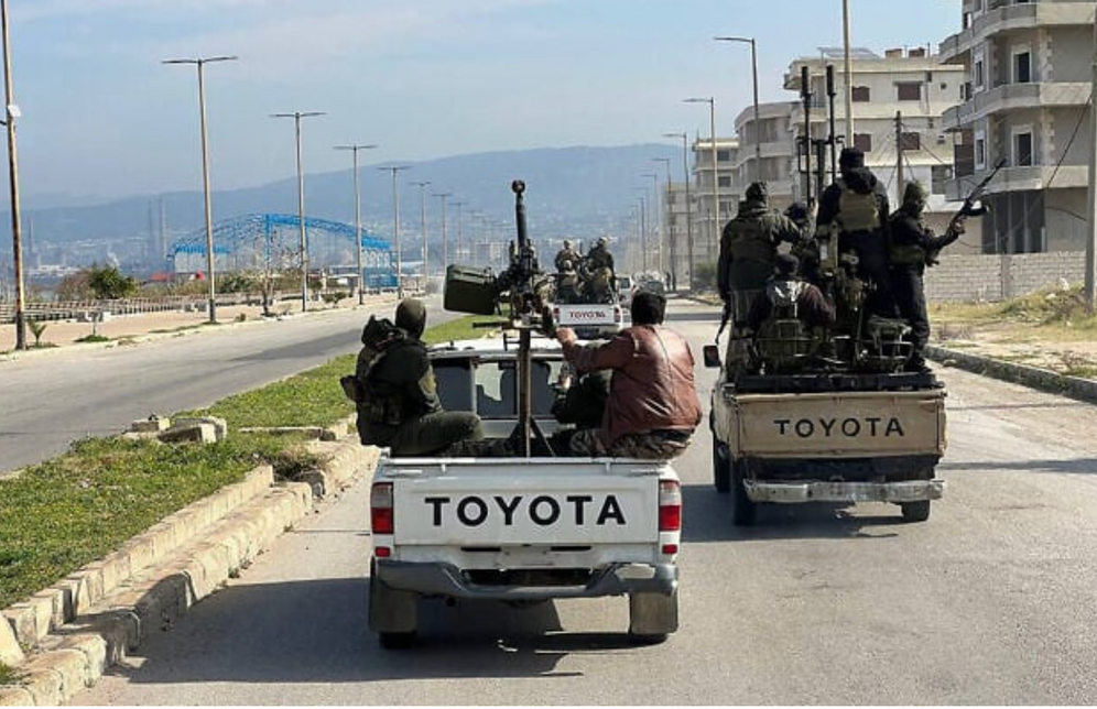 Syrian security forces entering the western town of Baniyas in Syria's coastal province of Tartus to reinforce government troops in clashes with militants loyal to ousted leader Bashar al-Assad