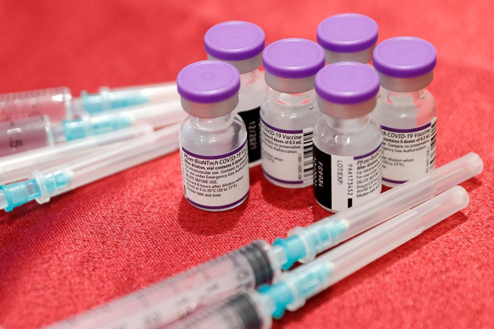 Syringes and vials of the Pfizer-BioNTech vaccine against the coronavirus are pictured at a private nursing home in the Israeli central coastal city of Netanya on January 5, 2022.