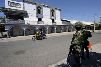 Soldiers from the 26th Infantry Battalion of the Mexican Army patrol the community of El Aguaje, in the municipality of Aguililla, Michoacan state, Mexico, on February 18, 2022.