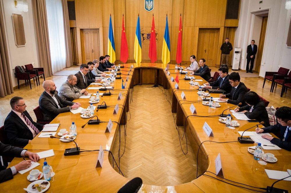 This handout picture taken by the Press Service of the Ukrainian Foreign Affairs Ministry, shows Ukrainian Foreign Minister Dmytro Kuleba (5thL) and China's special envoy Li Hui (4thR) attending a meeting during their talks in Kyiv, Ukraine.