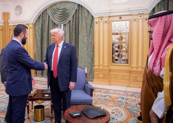 A handout picture provided by the Saudi Royal Palace shows Saudi Crown Prince Mohammed bin Salman (right) watching as US President Donald Trump (center) shakes hands with Syria's interim president Ahmed al-Sharaa in Riyadh 